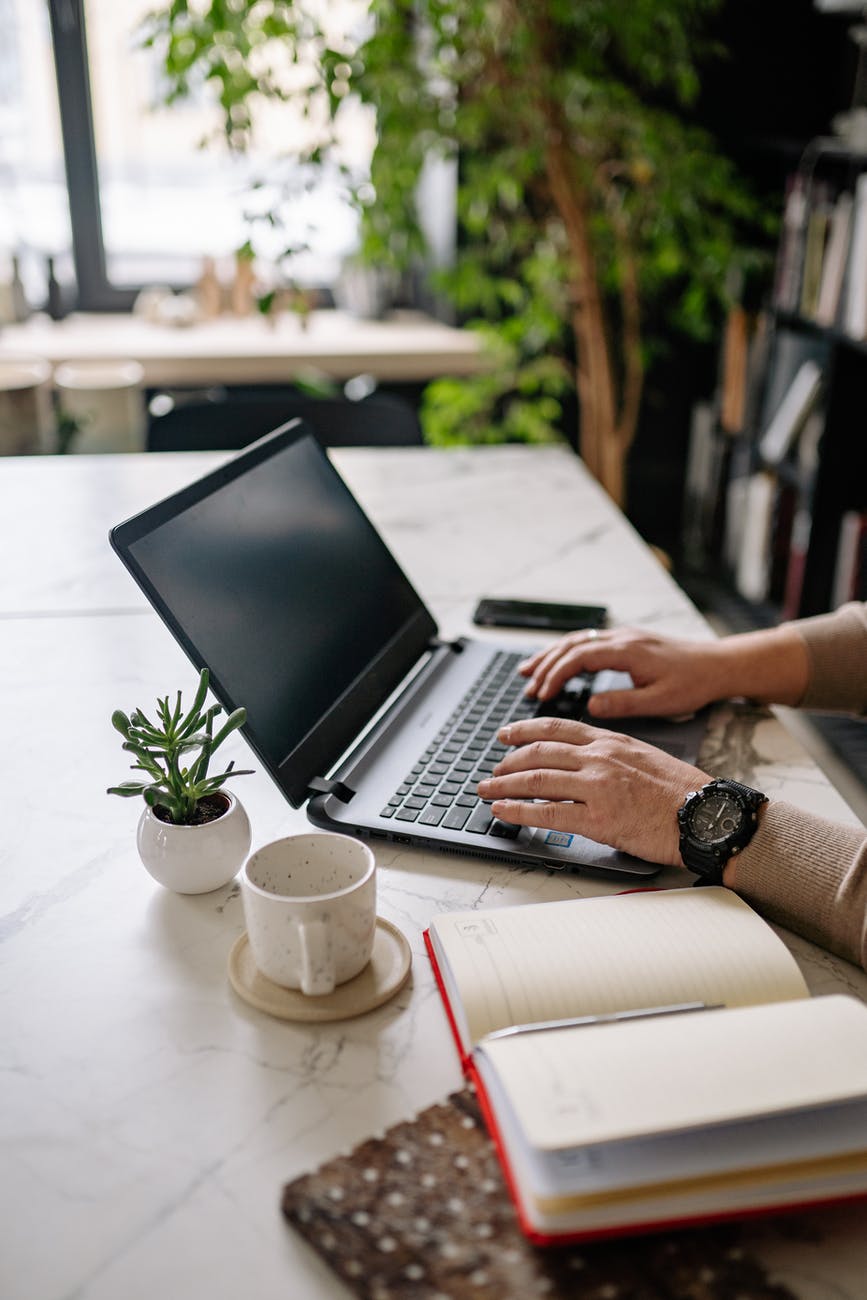 person using black and silver laptop computer